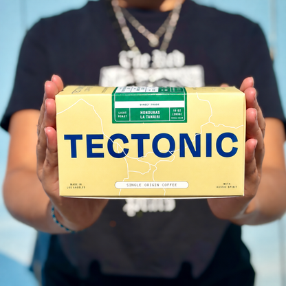Person holding Tectonic Honduras La Tanairi Natural coffee, 10 oz (283 g).