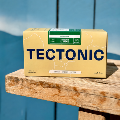 Tectonic Honduras La Tanairi Natural coffee box on a wooden bench, 10 oz (283 g).
