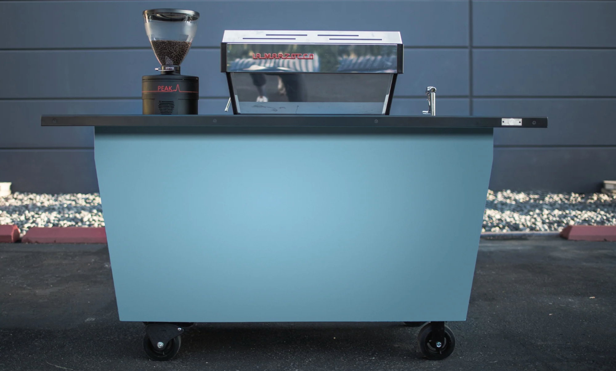 Coffee cart with coffee grinder and espresso machine on a blue background