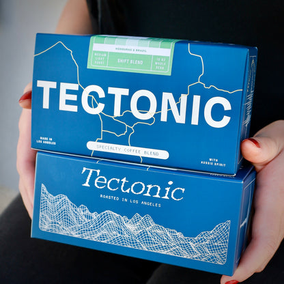 Tectonic Coffee Shift Blend 10oz box above a second blue Tectonic box; whole bean packaging shown